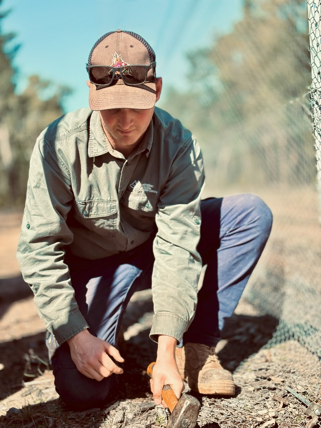 A person kneeling on the groundAI-generated content may be incorrect.