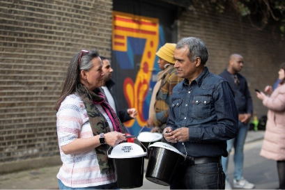 Decorative image of two people holding collecting buckets
