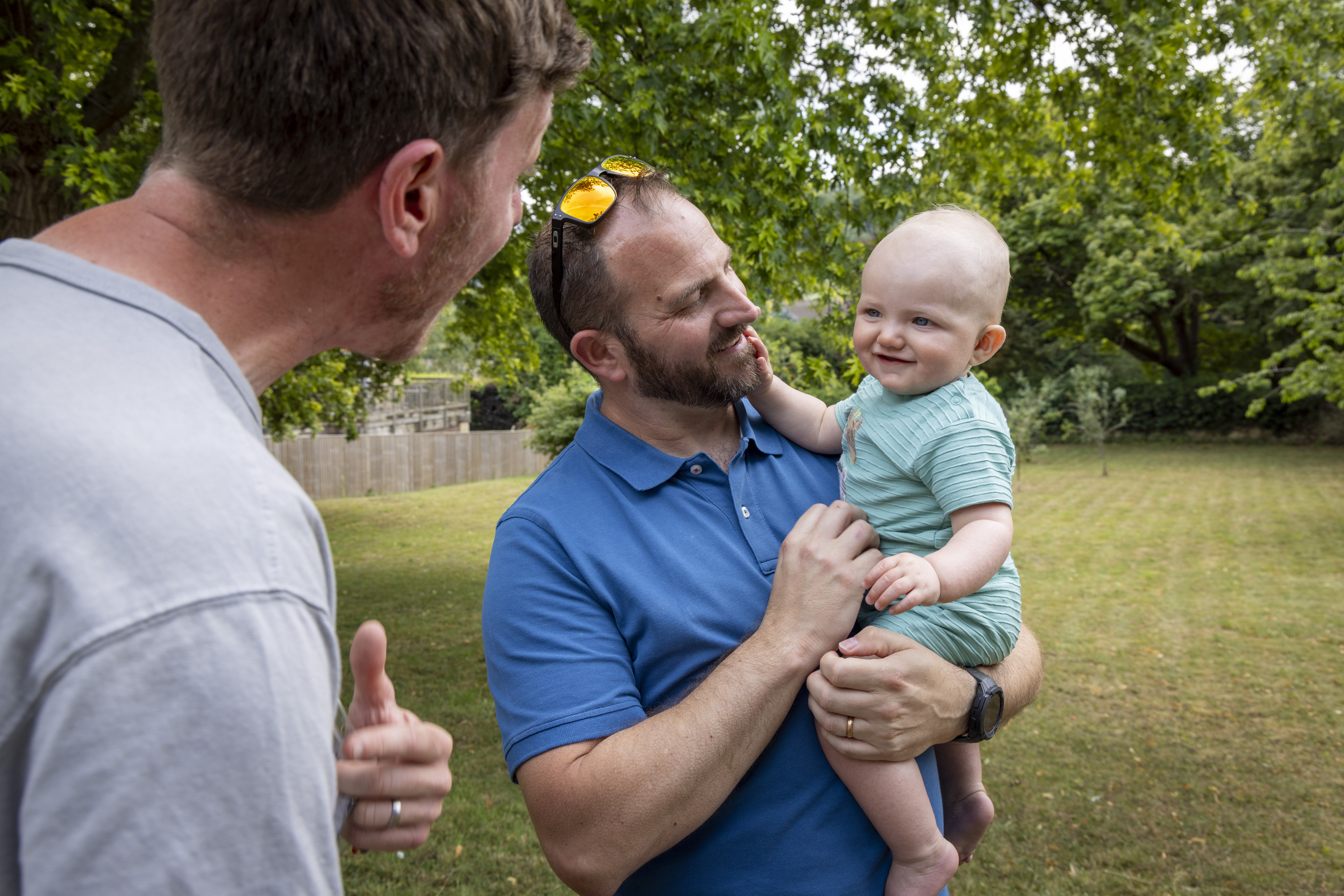 Dad with baby and volunteer