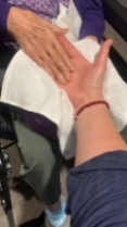 A person's hand with a towelAI-generated content may be incorrect.